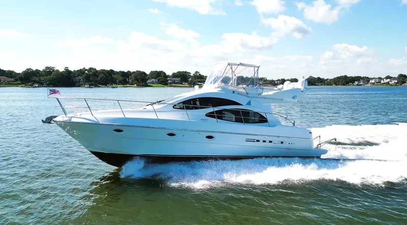 Slide: The Image of 2002 Azimut 42 yacht cruising on a sunny day, creating waves. - 8