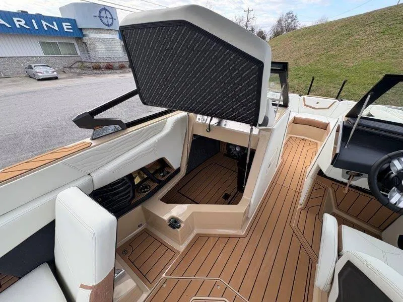 Slide: The Image of 2025 Nautique G25 boat interior with open storage compartment and sleek design. - 133