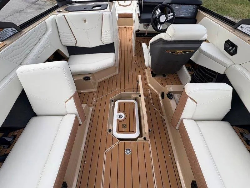 Slide: The Image of Luxurious interior of 2025 Nautique G25 boat with elegant seating and wood flooring. - 15
