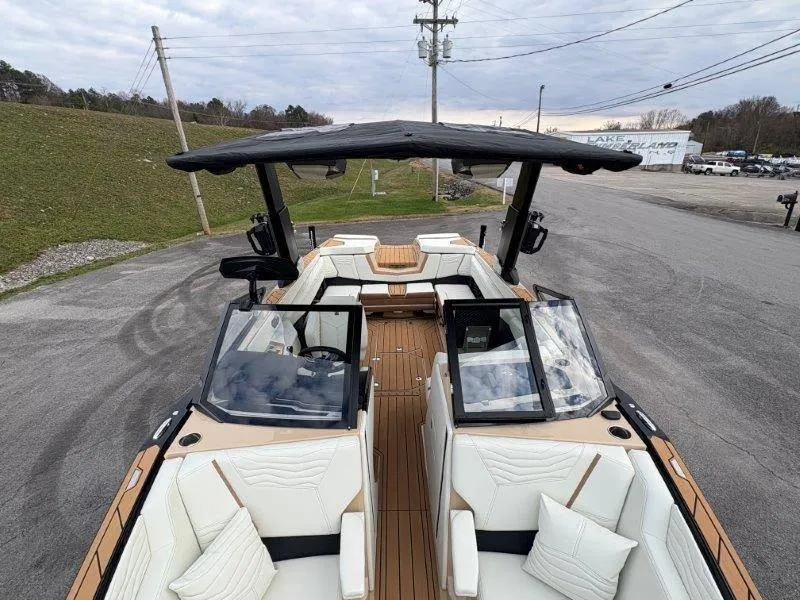 Slide: The Image of 2025 Nautique G25 boat with luxurious seating and sleek design on a cloudy day. - 17