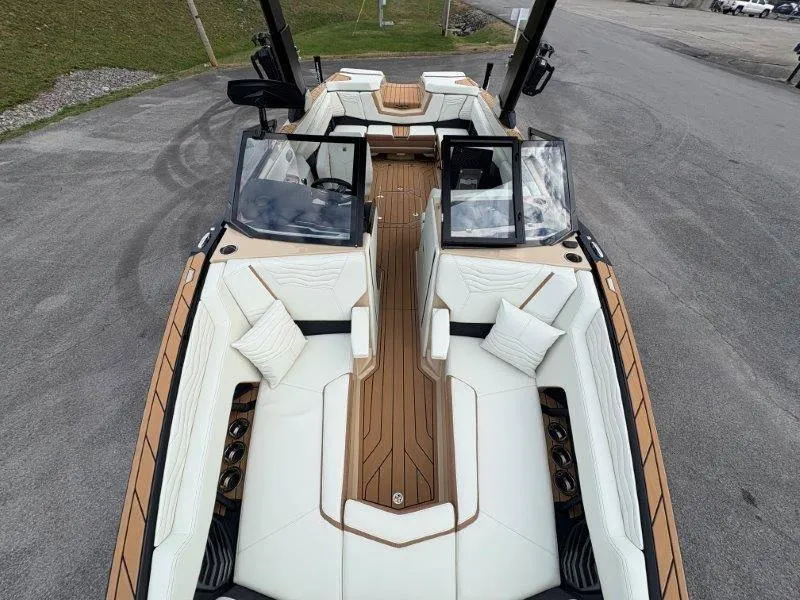 Slide: The Image of 2025 Nautique G25 boat interior with luxurious white seating and wooden accents. - 24