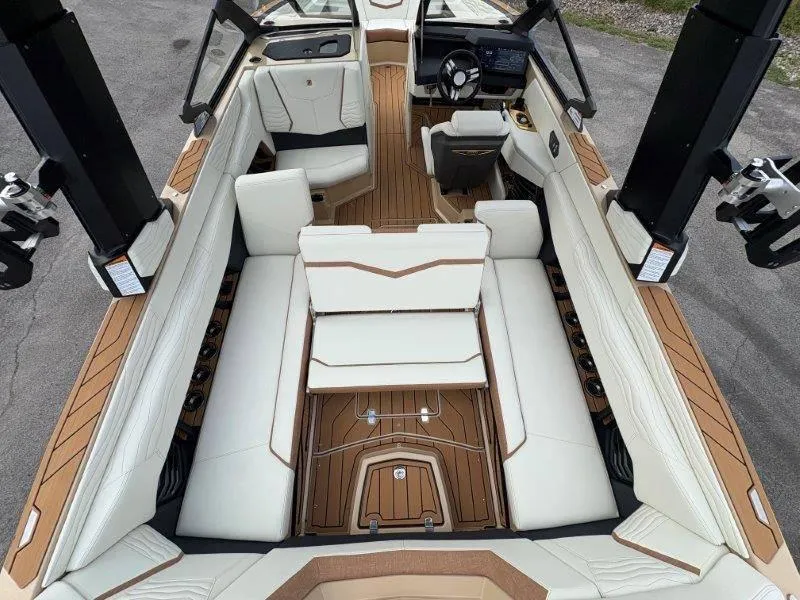 Slide: The Image of Luxurious interior of 2025 Nautique G25 boat with white seating and wood accents. - 27