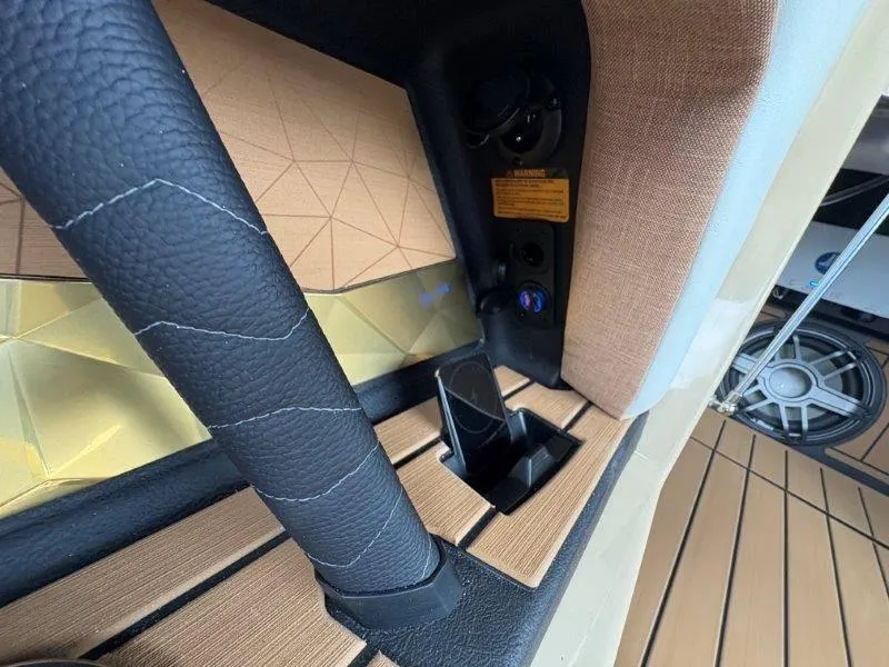 Slide: The Image of Interior detail of 2025 Nautique G25 boat with leather accents and speaker system. - 29