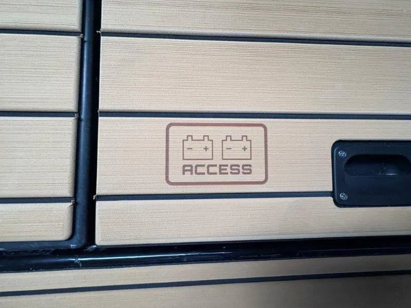 Slide: The Image of 2025 Nautique G25 battery access panel with wood finish. - 31