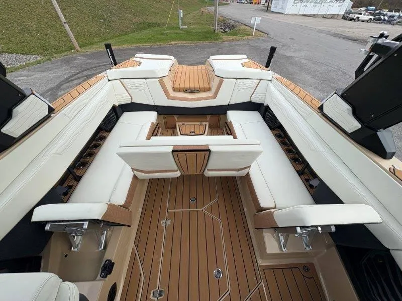 Slide: The Image of 2025 Nautique G25 boat interior with luxurious seating and teak flooring. - 37