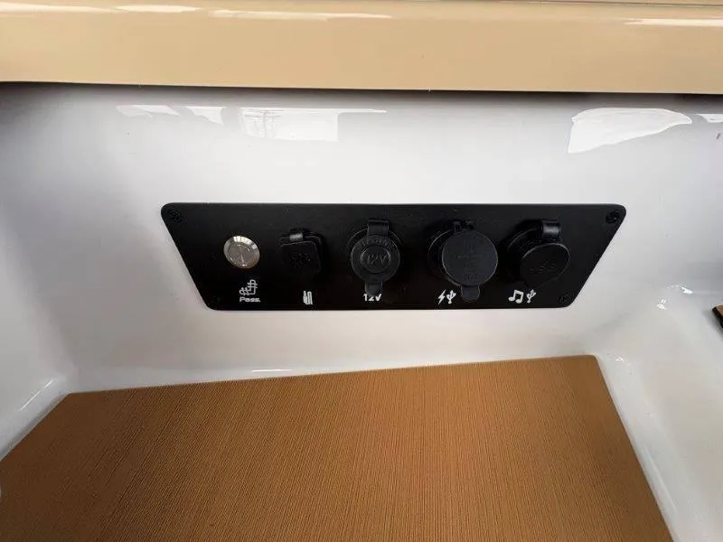 Slide: The Image of 2025 Nautique G25 control panel with various power and audio ports. - 38