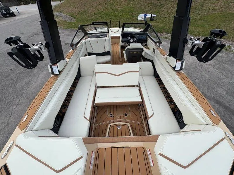 Slide: The Image of 2025 Nautique G25 boat interior with luxurious white seating and teak flooring. - 42