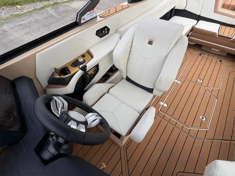 Slide: The Image of 2025 Nautique G25 boat interior with luxurious seating and modern steering wheel. - 49