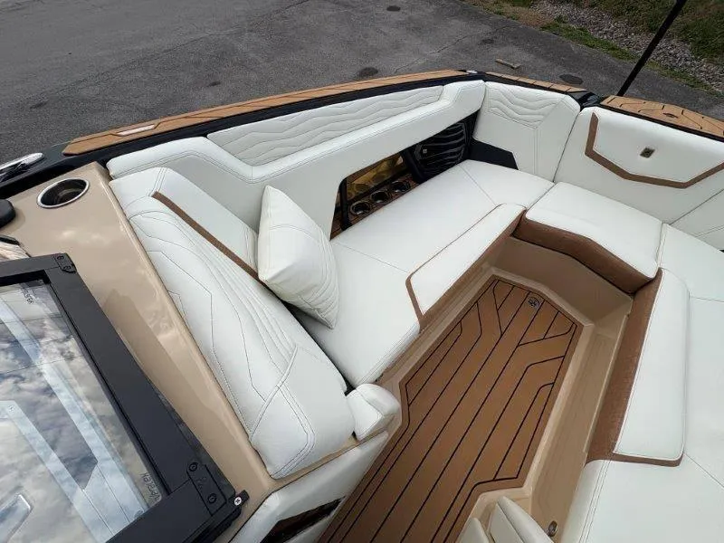 Slide: The Image of Luxurious interior of 2025 Nautique G25 boat with white leather seating. - 6