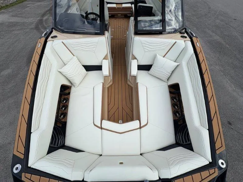 Slide: The Image of 2025 Nautique G25 boat interior with luxurious white seating and wooden accents. - 7