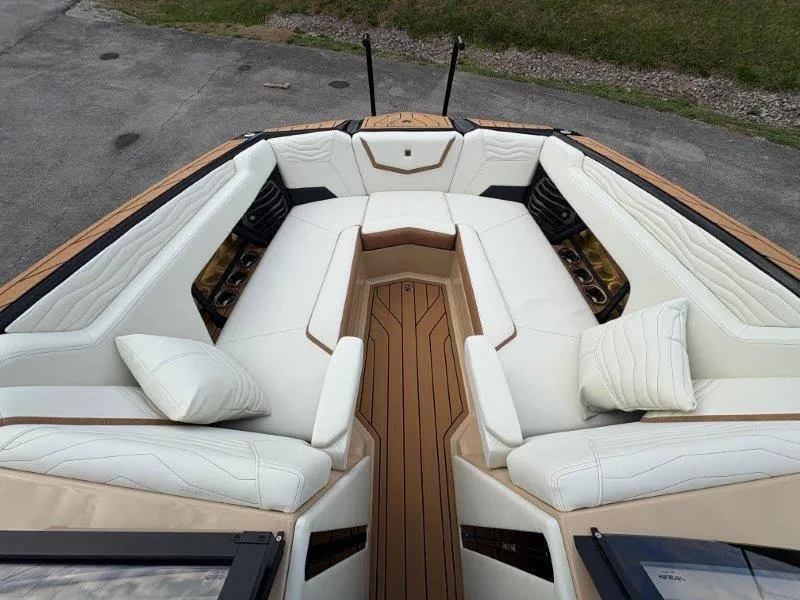 Slide: The Image of Luxurious interior of 2025 Nautique G25 boat with white seating and wood accents. - 8