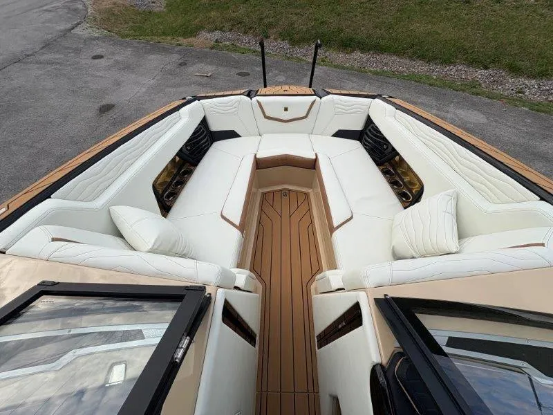 Slide: The Image of Luxurious interior of 2025 Nautique G25 boat with white seating and wood accents. - 9