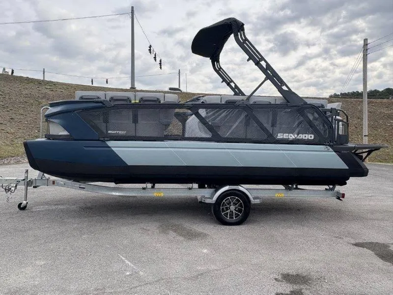 Slide: The Image of 2025 Sea-Doo Switch Cruise Limited 21' 230HP pontoon boat on trailer, parked outdoors. - 17