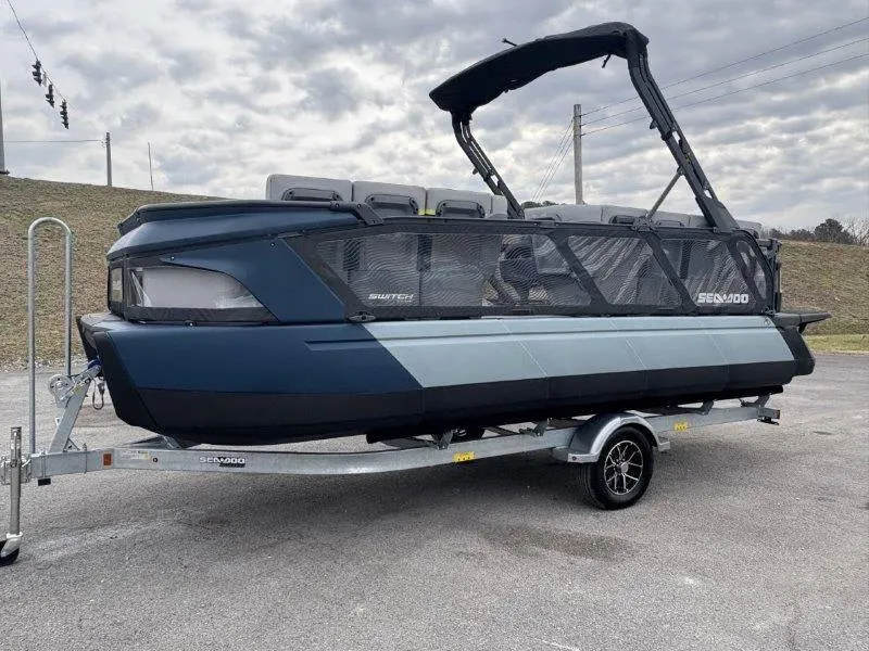 Slide: The Image of 2025 Sea-Doo Switch Cruise Limited 21' 230HP on trailer, parked outdoors under cloudy sky. - 20
