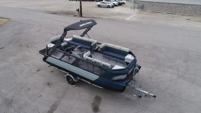 Slide: The Image of 2025 Sea-Doo Switch Cruise Limited 21' 230HP pontoon boat on trailer, parked outdoors. - 3
