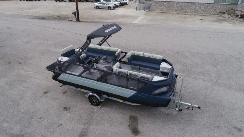 Slide: The Image of 2025 Sea-Doo Switch Cruise Limited 21' 230HP pontoon boat on trailer, parked in lot. - 5