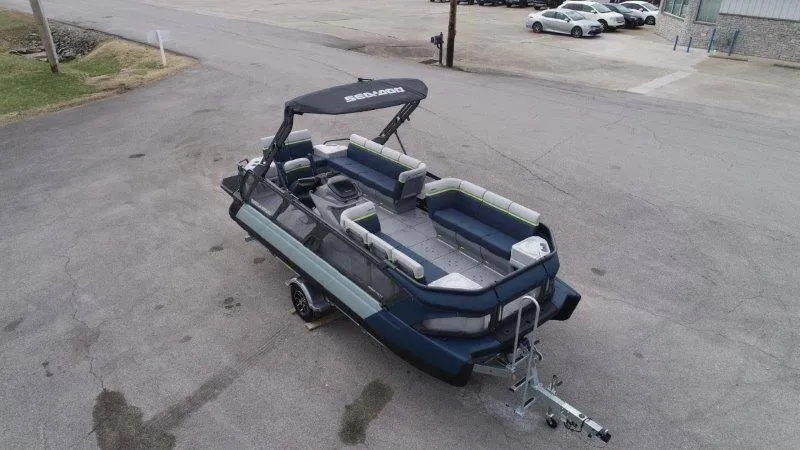 Slide: The Image of 2025 Sea-Doo Switch Cruise Limited 21' 230HP pontoon boat on trailer, parked in lot. - 6