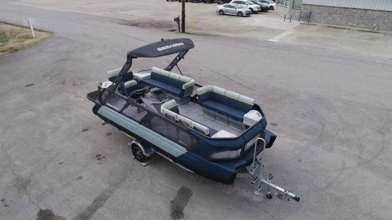 Slide: The Image of 2025 Sea-Doo Switch Cruise Limited 21' 230HP pontoon boat on trailer, parked in lot. - 9