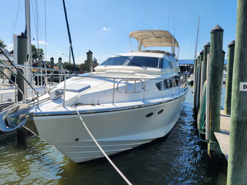 Slide: The Image of 1987 Posillipo Technema 52 yacht docked at marina under clear blue sky. - 1