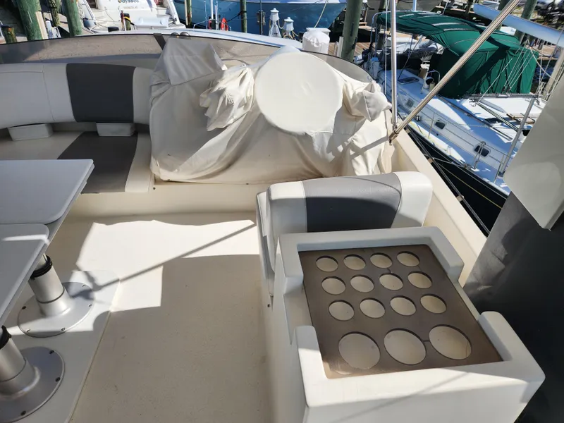Slide: The Image of 1987 Posillipo Technema 52 yacht deck with seating and table, docked at marina. - 11