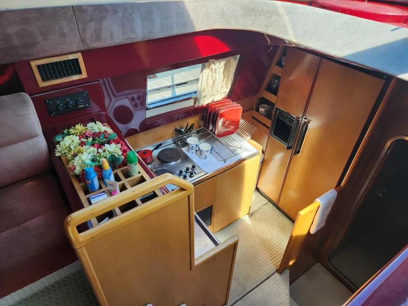 Slide: The Image of Interior of 1987 Posillipo Technema 52 yacht kitchen with stove, sink, and wooden cabinetry. - 13