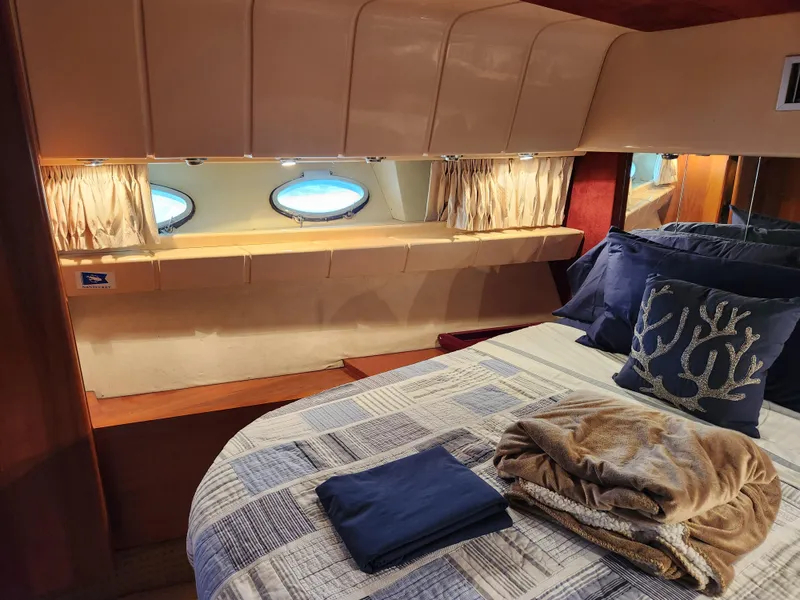 Slide: The Image of Cozy bedroom interior of 1987 Posillipo Technema 52 yacht with porthole windows and nautical decor. - 14