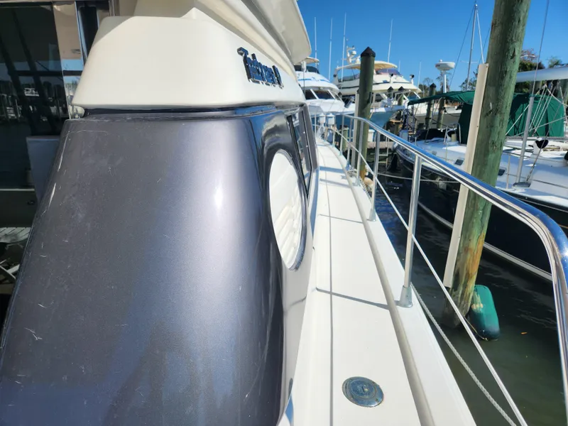 Slide: The Image of 1987 Posillipo Technema 52 yacht docked, showcasing sleek design and polished railings. - 17