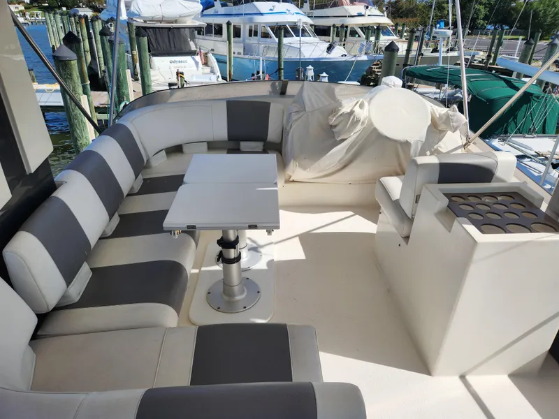Slide: The Image of Luxurious 1987 Posillipo Technema 52 yacht deck with seating and table, docked at marina. - 20