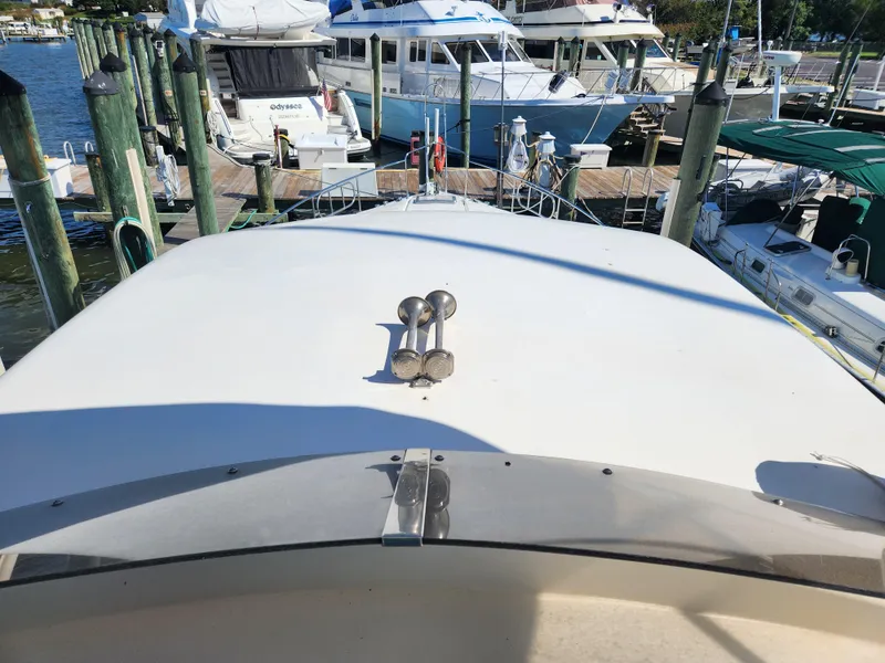 Slide: The Image of 1987 Posillipo Technema 52 yacht docked at a marina, surrounded by other boats. - 21