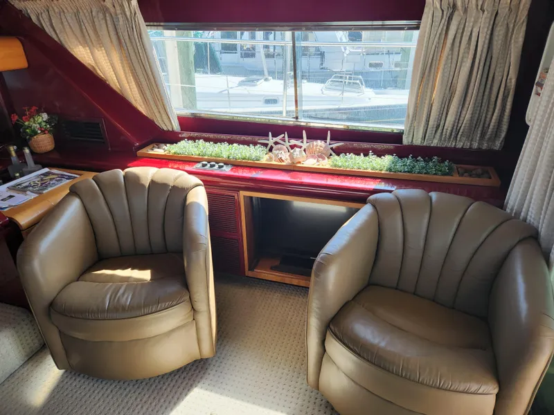 Slide: The Image of Interior of 1987 Posillipo Technema 52 yacht with leather chairs and decorative plants. - 25