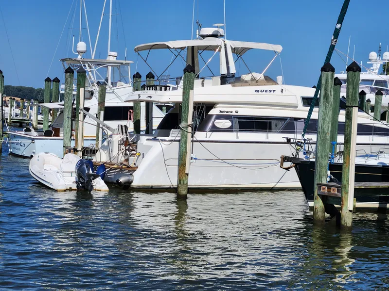 Slide: The Image of 1987 Posillipo Technema 52 yacht docked at a marina, surrounded by calm waters. - 3