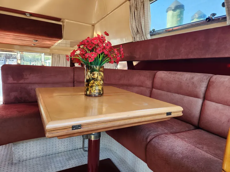 Slide: The Image of Luxurious interior of 1987 Posillipo Technema 52 yacht with elegant dining area and floral centerpiece. - 31