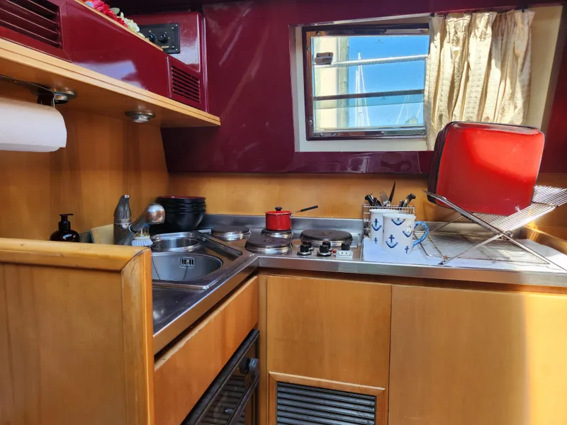 Slide: The Image of Interior of 1987 Posillipo Technema 52 yacht kitchen with sink, stove, and window. - 33