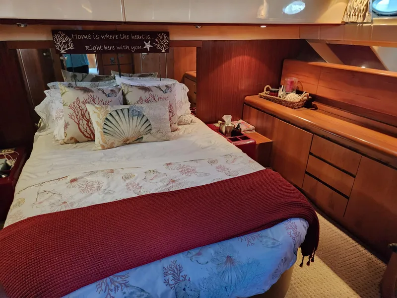 Slide: The Image of Luxurious bedroom interior of 1987 Posillipo Technema 52 yacht with elegant bedding and wood accents. - 39