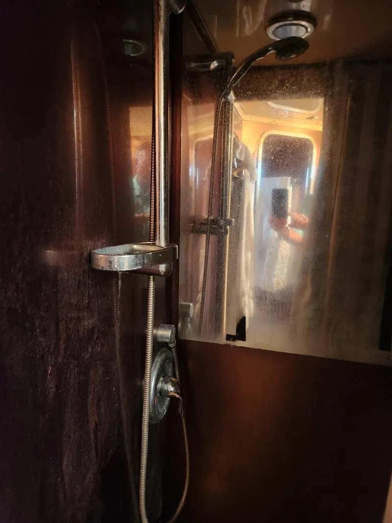 Slide: The Image of Shower area inside a 1987 Posillipo Technema 52 yacht, featuring chrome fixtures. - 43