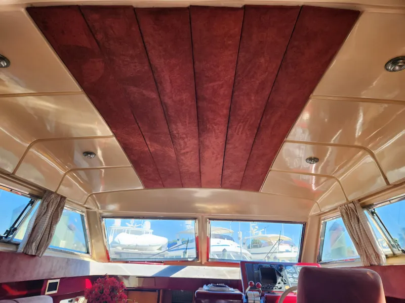 Slide: The Image of Interior view of 1987 Posillipo Technema 52 yacht with red ceiling panels and large windows. - 46