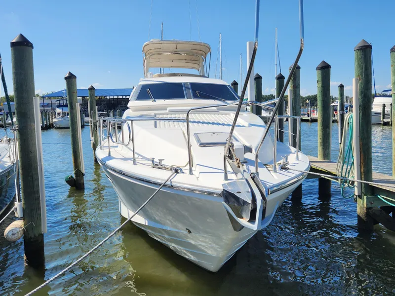 Slide: The Image of 1987 Posillipo Technema 52 yacht docked at marina, sunny day, clear blue sky. - 6