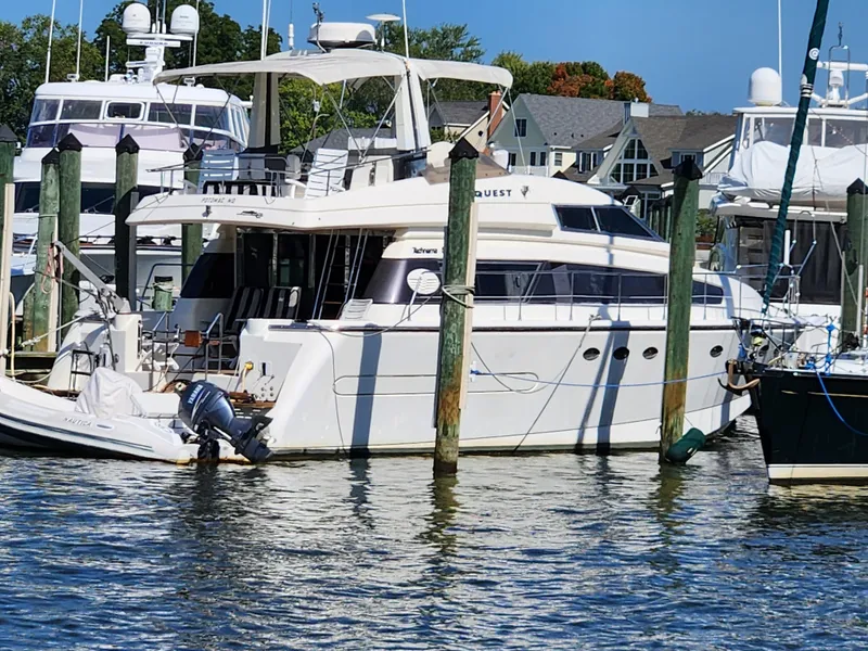 Slide: The Image of 1987 Posillipo Technema 52 yacht docked at a marina with surrounding boats. - 7