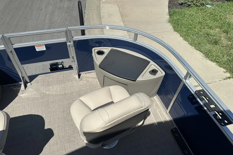 Slide: The Image of 2025 Sun Tracker Fishin' Barge 22 DLX interior with seating and console. - 10