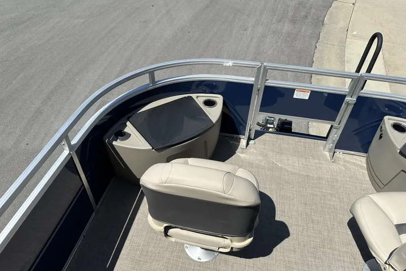 Slide: The Image of 2025 Sun Tracker Fishin' Barge 22 DLX interior with seating and cup holders. - 14