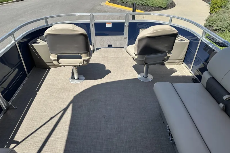 Slide: The Image of 2025 Sun Tracker Fishin' Barge 22 DLX interior with seating and open deck space. - 13