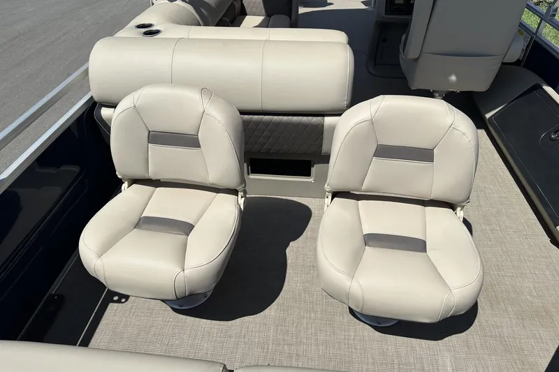 Slide: The Image of 2025 Sun Tracker Fishin' Barge 22 DLX boat seats, beige upholstery, spacious deck layout. - 22
