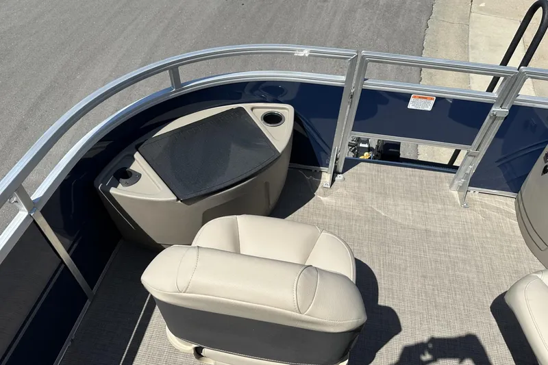 Slide: The Image of 2025 Sun Tracker Fishin' Barge 22 DLX interior with seating and railing. - 12
