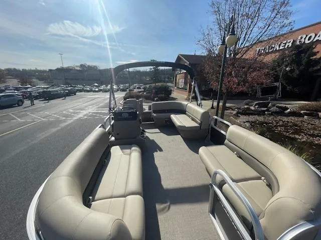 Slide: The Image of 2025 Sun Tracker Party Barge 16 DLX pontoon boat with spacious seating in a parking lot. - 2