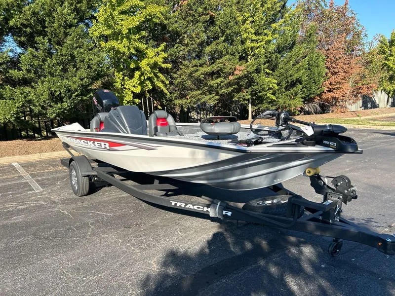 Slide: The Image of 2025 Tracker Pro Team 195 Tournament Edition boat on trailer in parking lot. - 2