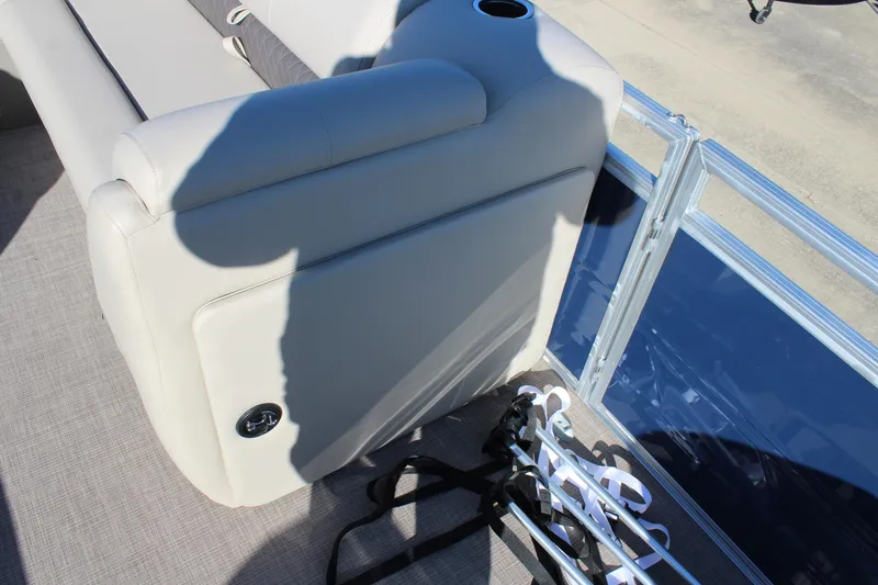 Slide: The Image of Sun Tracker Fishin' Barge 22 DLX 2025 interior with seating and cup holder. - 12
