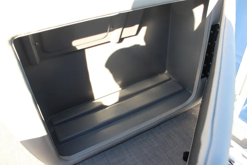 Slide: The Image of 2025 Sun Tracker Fishin' Barge 22 DLX storage compartment, open and empty. - 13