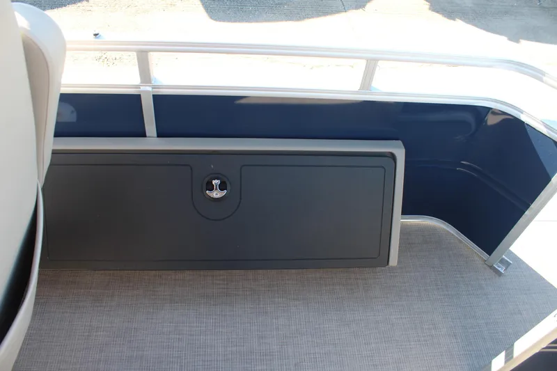 Slide: The Image of Sun Tracker Fishin' Barge 22 DLX 2025, interior storage compartment, blue and gray design. - 19
