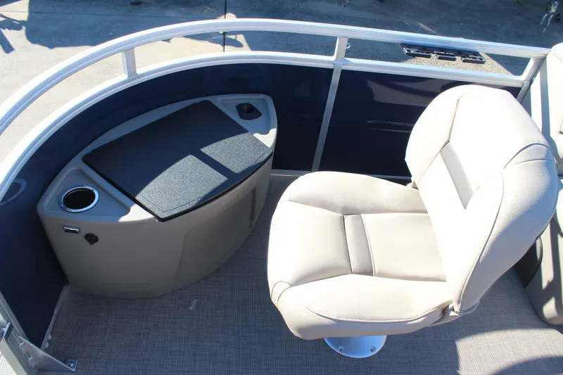 Slide: The Image of 2025 Sun Tracker Fishin' Barge 22 DLX interior with seating and storage. - 9