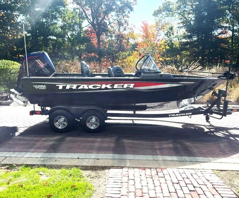 The Image of 2025 Tracker Targa V-19 WT boat on trailer, parked outdoors near a building. - 0